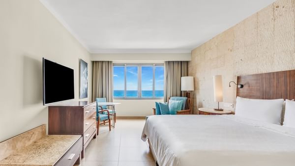 TV & sitting area facing the bed in Premium Ocean Front, 1 King at Fiesta Americana