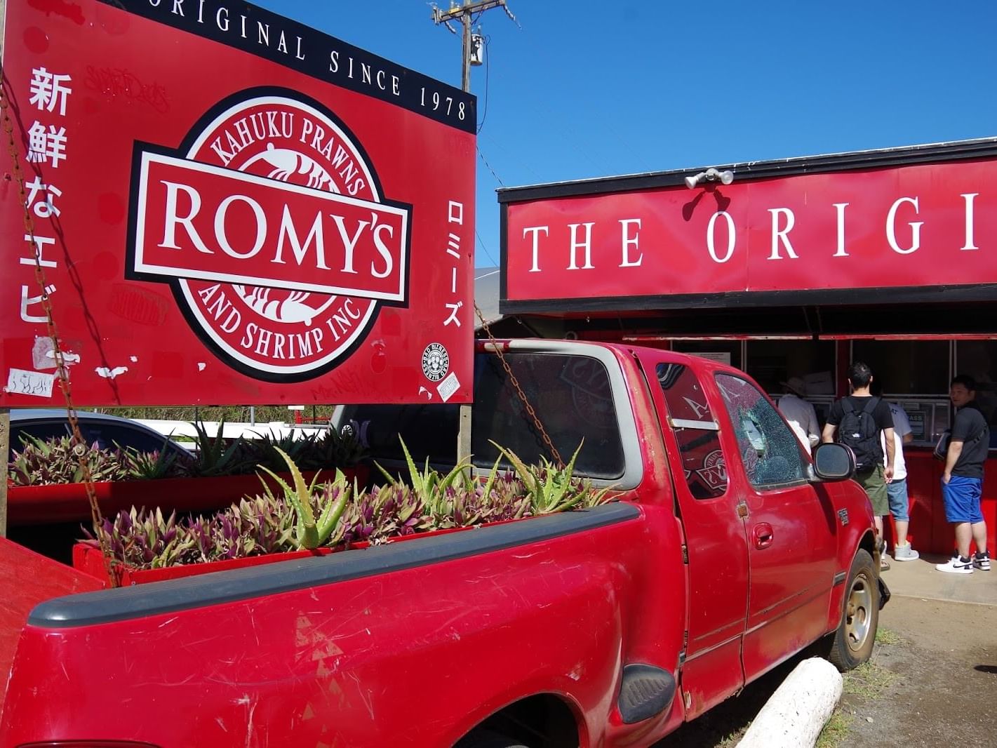 Outdoor signboard and entrance to Romy's Kahuku Prawns & Shrimp near Waikiki Resort Hotel by Sono