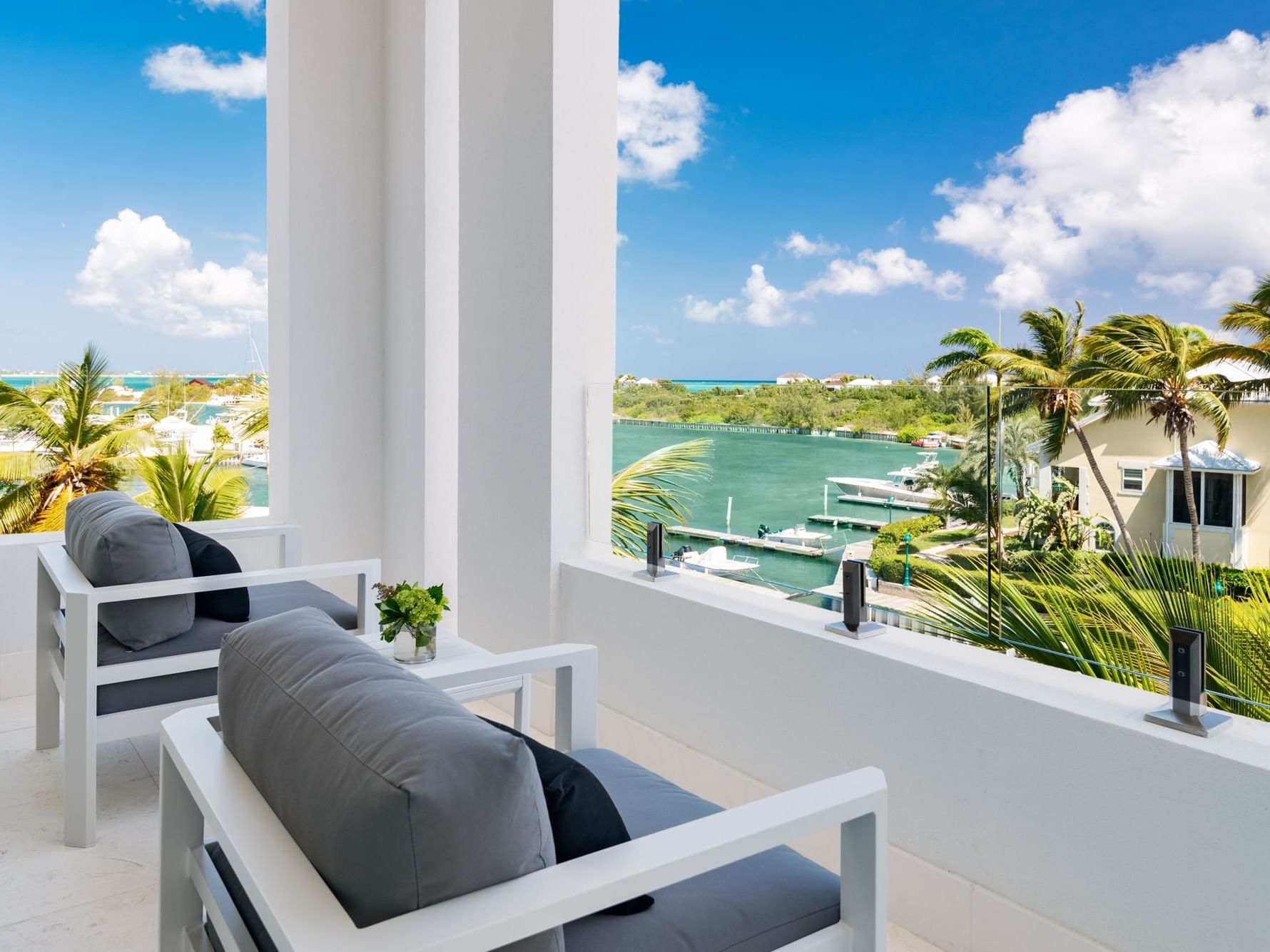 Chairs on a balcony facing the sea in Double Deluxe Ocean View at Zenza Hotel