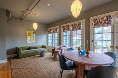 Dining table by plush seating area of Grand King Suite at The Ashbrook Hotel, one of the best hotels in Kentucky