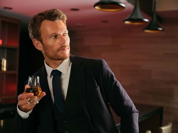 A man holding a glass of champagne at ReStays Ottawa