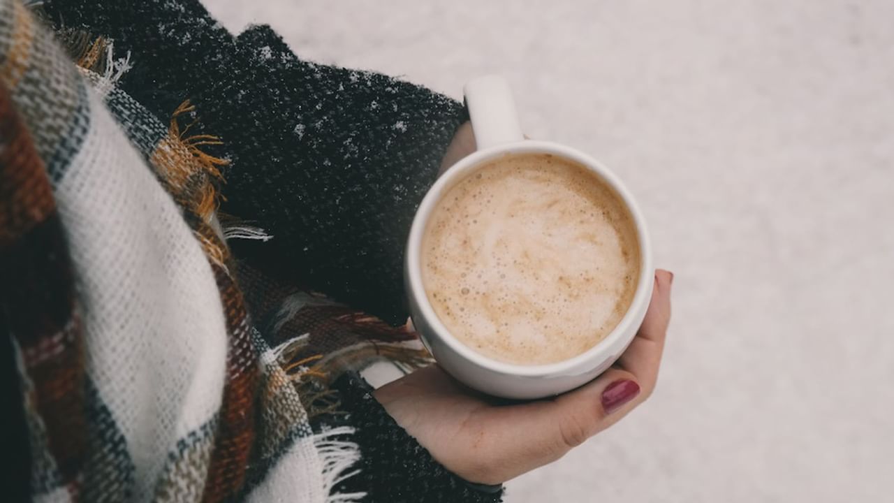 Someone holding cup of hot chocolate outdoors