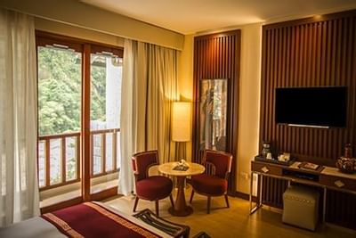 Interior of a room with dining table & balcony at Hotel Sumaq