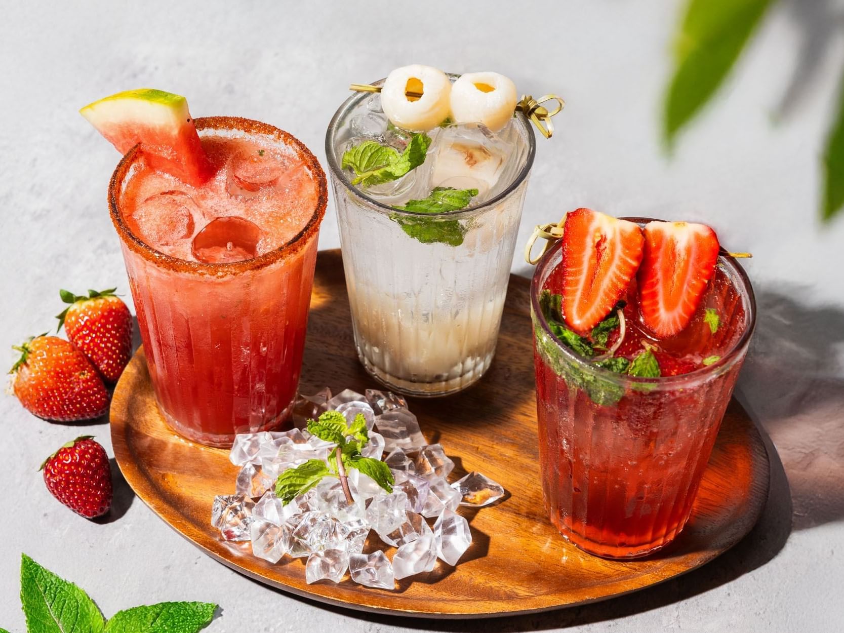  A wooden tray displaying three distinct types of beverages, showcasing their unique colors and presentations.