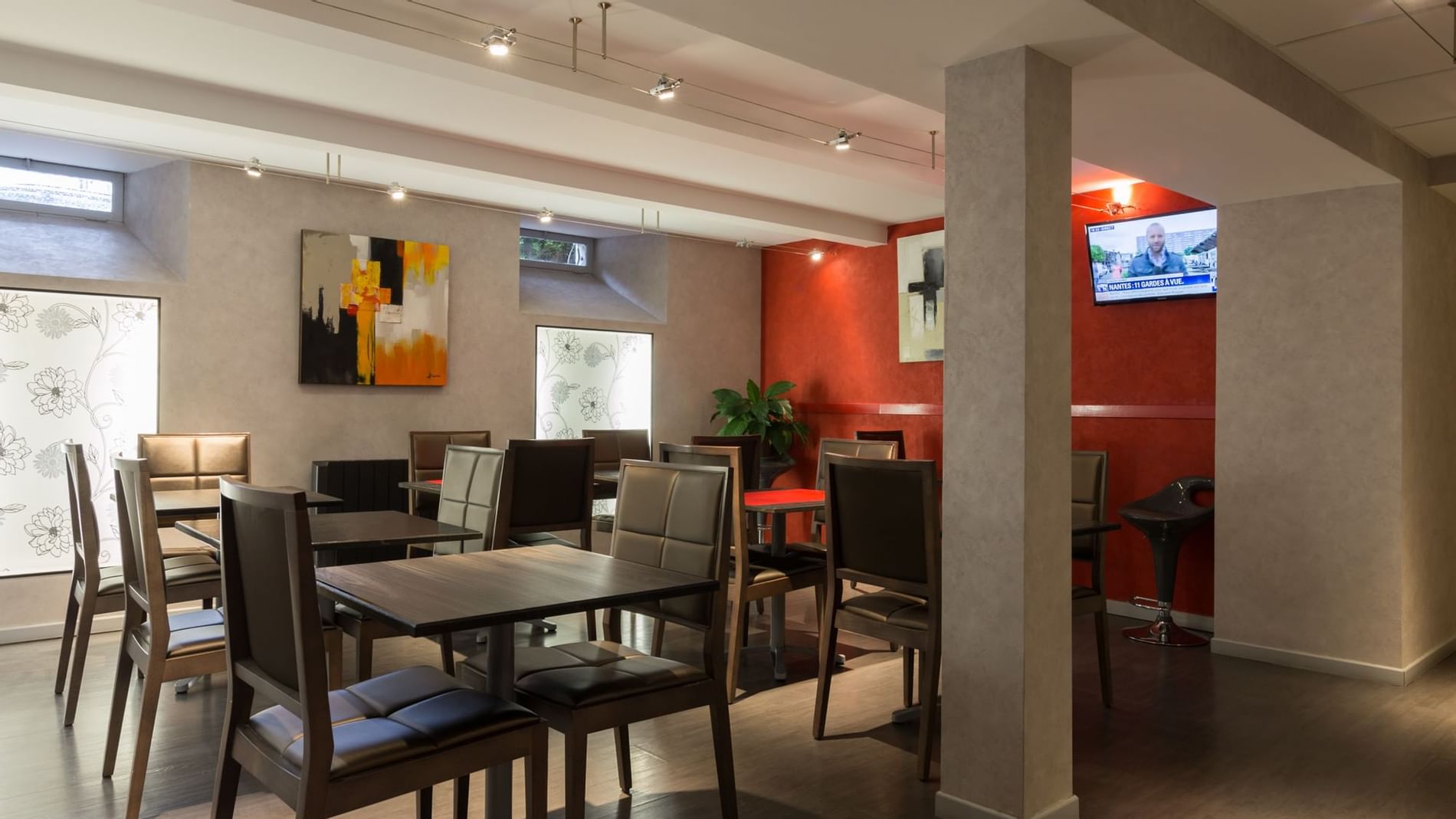 Dining area with TV in a restaurant at Originals Hotels