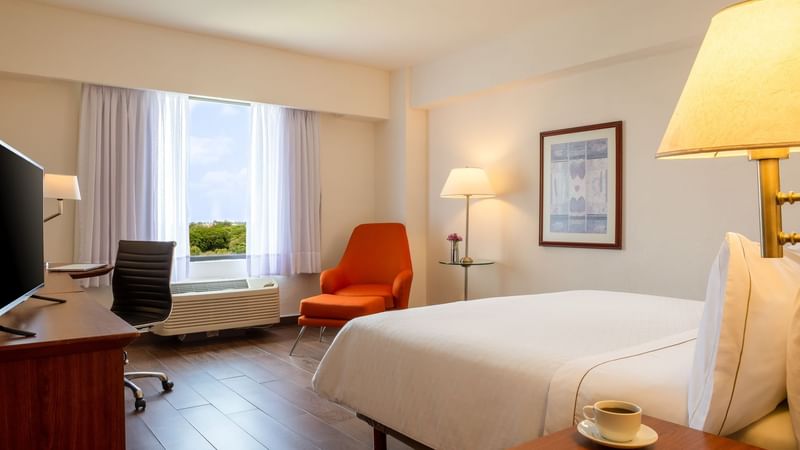 Work desk & king bed in a guest room at Fiesta Inn Tampico