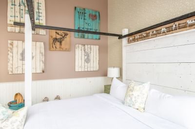 Canopy bed, comfy pillows & paintings on the wall in Superior Loft Cottage at Retro Suites Hotel