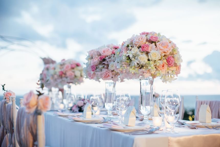 Wedding table arranged with flower vases at Momentus Hotel Alexandra