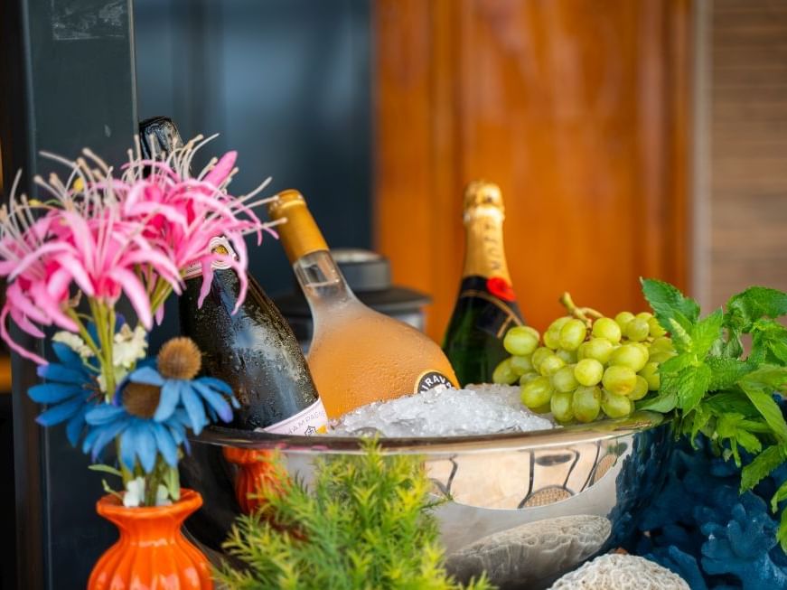 Stijlvolle ijsemmer met drie flessen champagne, bloemen, druiven en munt bij de Pool Bar, Golden Rock Resor