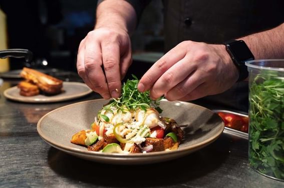 A chef plating a dish in a Restaurant at ReStays Ottawa