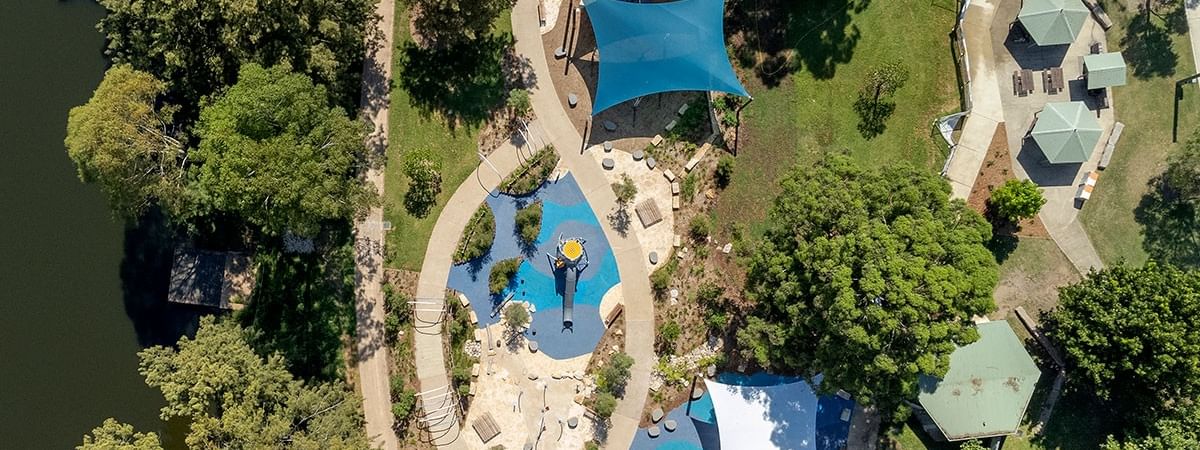 Aerial view of Tench Reserve with pathways, play areas, and blue canopies.