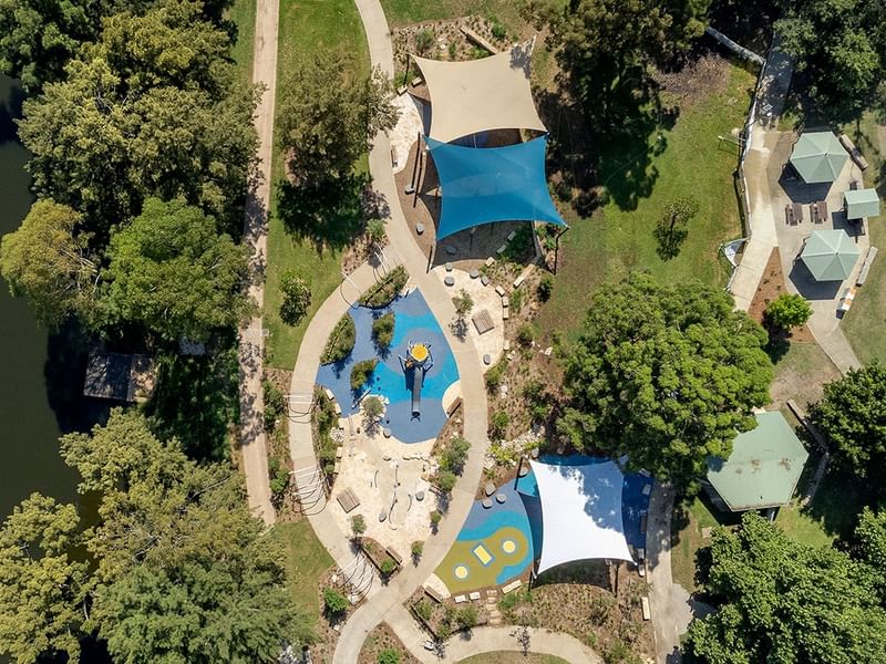Aerial view of Tench Reserve with pathways, play areas, and blue canopies.