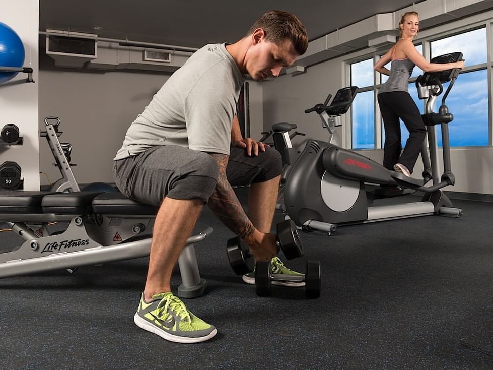 Couple exercising in Fitness Center, Applause Hotel Calgary