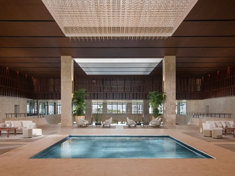 Indoor pool area by the lobby lounge at Live Aqua Resorts