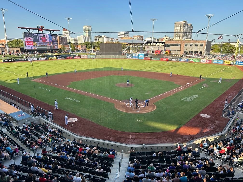 A baseball field with a crowd of people watching a game