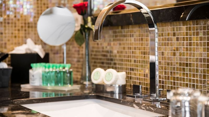 Vanity area with various toiletries in Grand Place Suite at Warwick Brussels