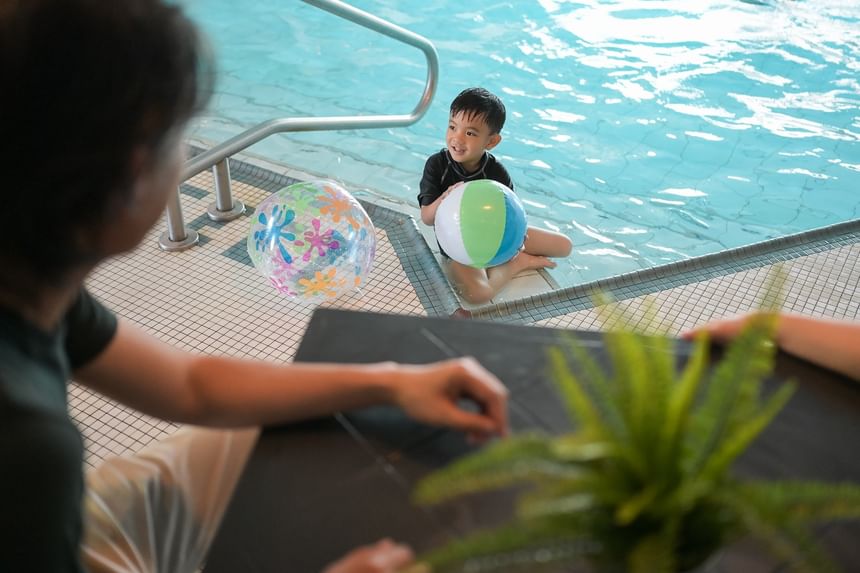 Over-the-shoulder view of family at the indoor pool of Rodd Grand Yarmouth, a leading Yarmouth hotel with pool