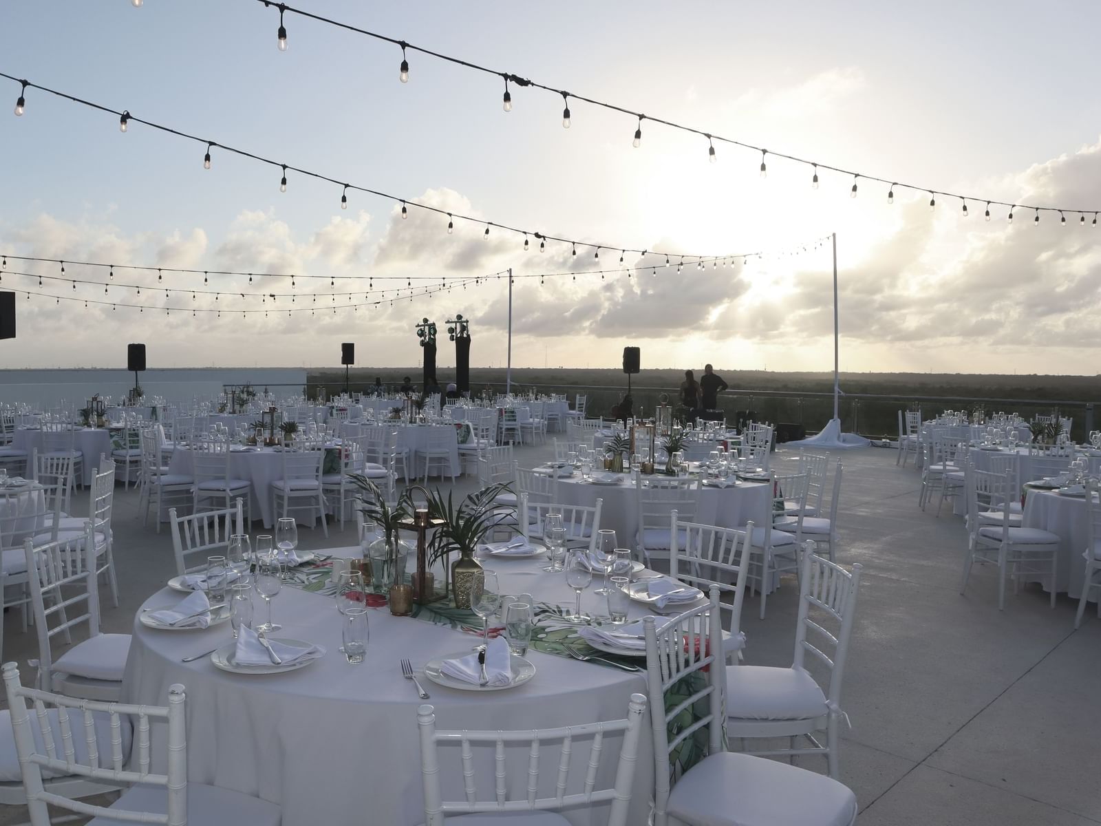 Banquet-style dining tables set-up in sunset terrace at Haven Riviera Cancun