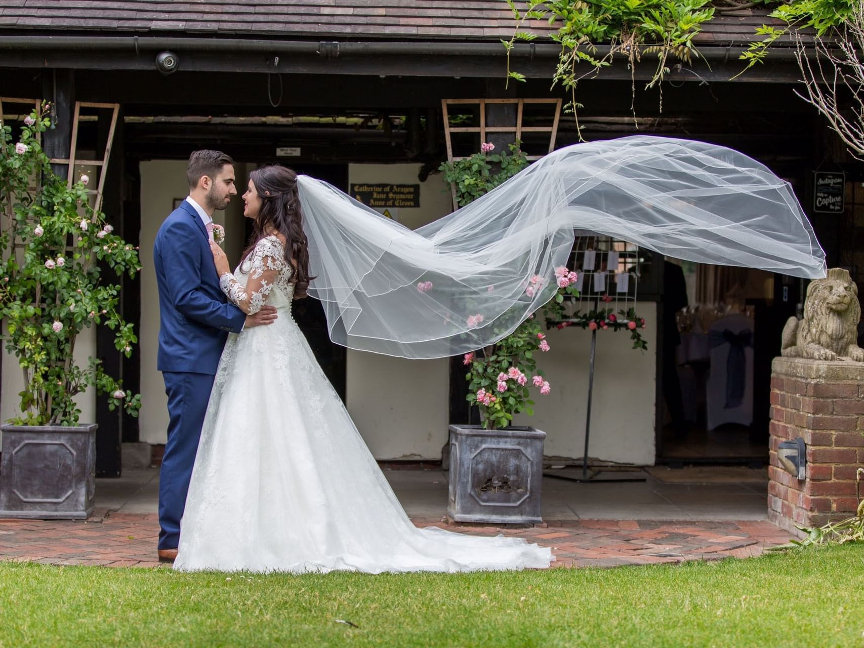 Beautiful wedding photo at Marygreen Manor, capturing the couple with the bride’s long veil flowing in the wind