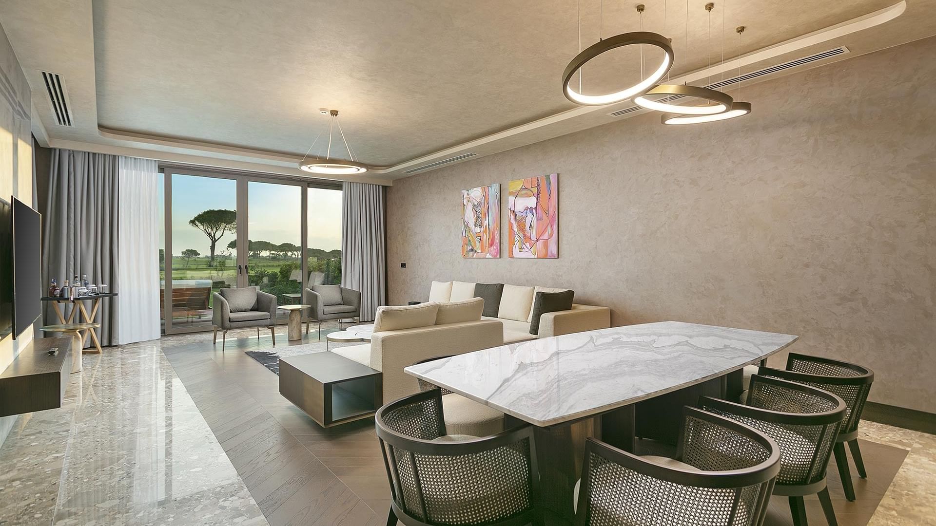 Dining table by lounge area with view of outdoors in Cullinan Villa at Cullinan Belek