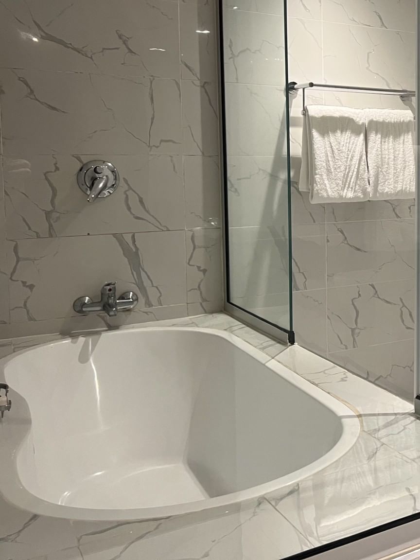 Modern bathroom with bathtub, shower, toilet, and sink at Warwick Fiji Resort and Spa in Korolevu.