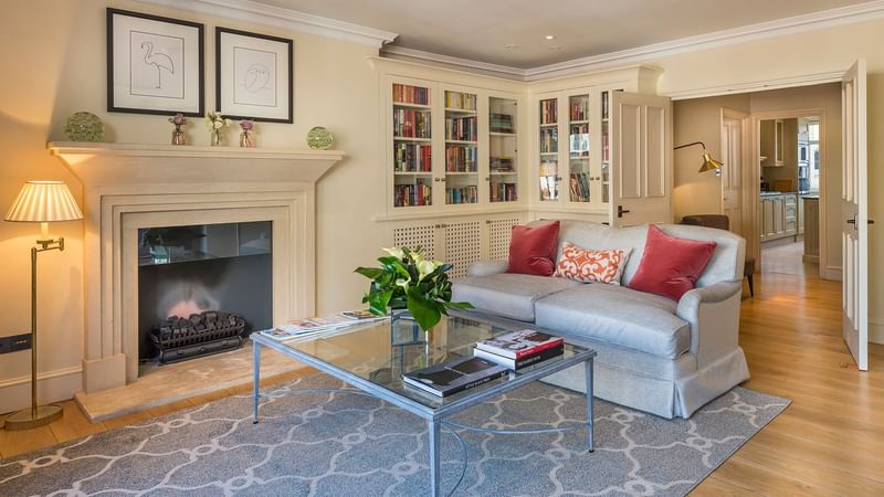 Living Room with fireplace, comfy sofa and coffee table in The Penthouse at Capital Hotel