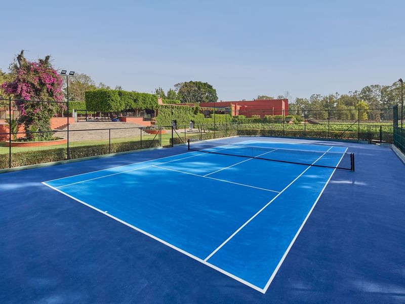 Outdoor tennis court & hotel view at FA Hotels & Resorts