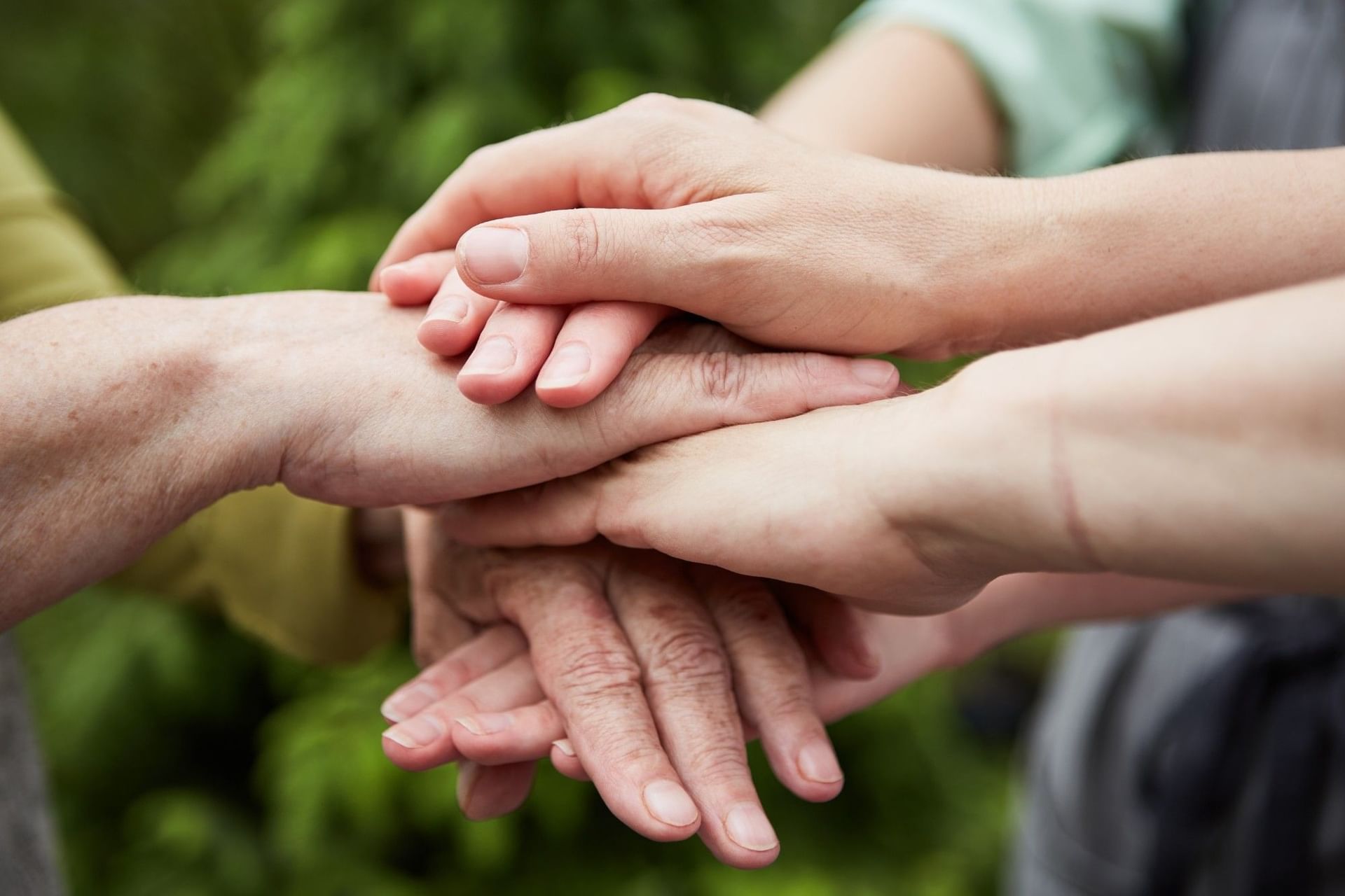 Close up of several hands stacked together in a circle at Novotel Sydney Olympic Park