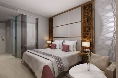 Large bed, lamps & lounge area in a room at Azalai Hotel Dakar