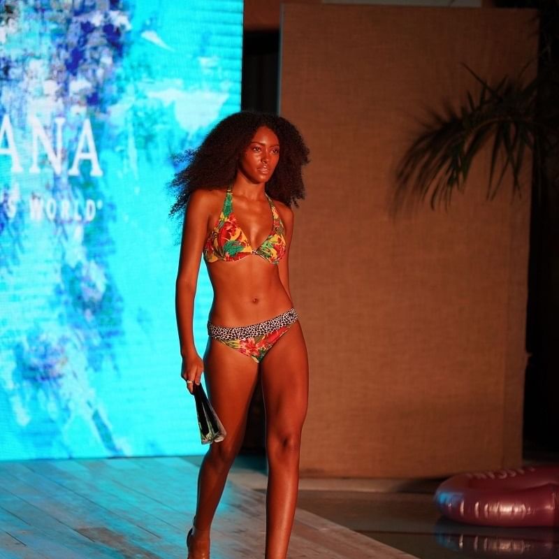 A model in a swimsuit walks the runway near Casa Boutique Hotel