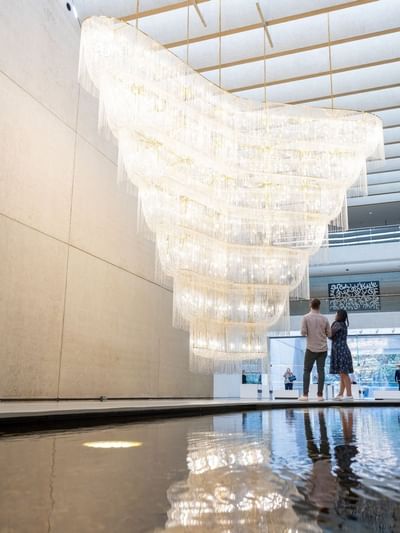 Interior of QAGOMA with a large cascading chandelier near Sofitel Brisbane Central