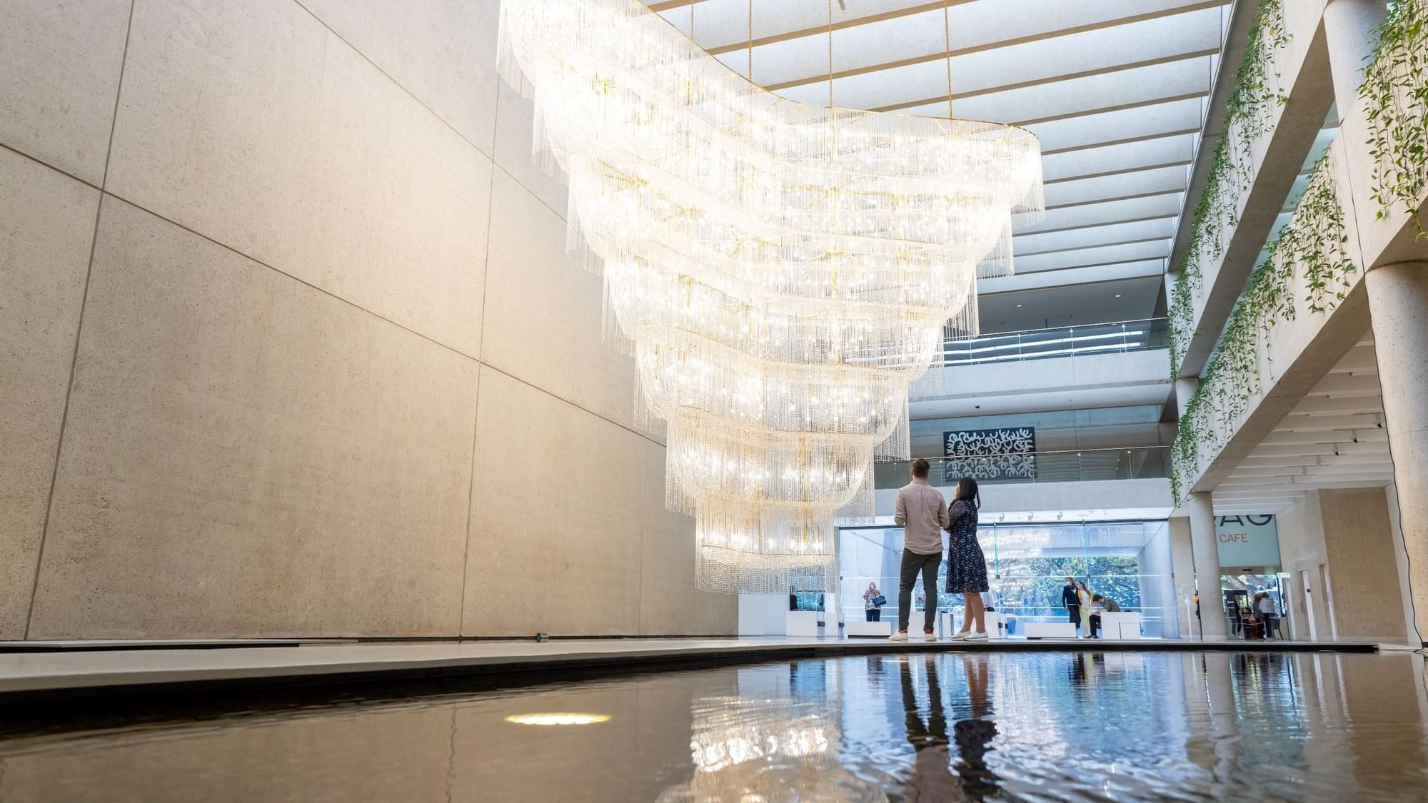 Interior of QAGOMA with a large cascading chandelier near Sofitel Brisbane Central