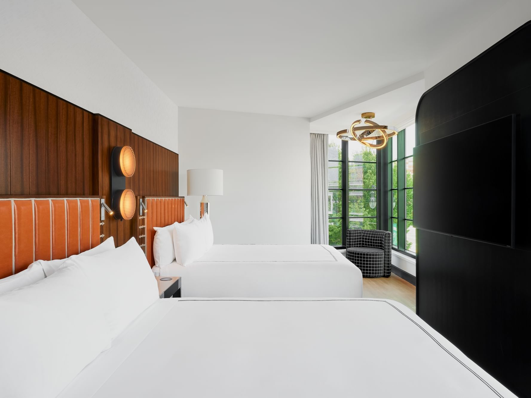 TV-facing bed with modern interior in 2 Queen Beds Deluxe Corner Room at Godfrey Hotel Detroit