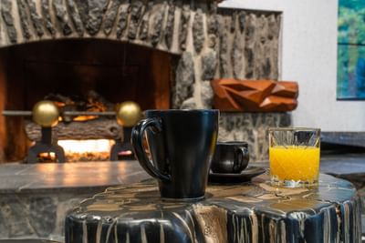 Coffee and orange juice in front of the lobby fireplace