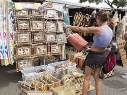 Lady shopping in Aloha Stadium Swap Meet near Paradise Bay Resort