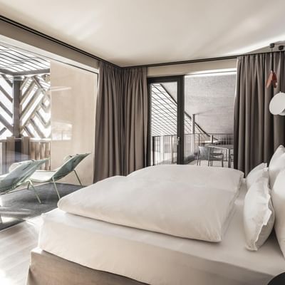Large bed in Grand Suites Lido at Falkensteiner Hotels