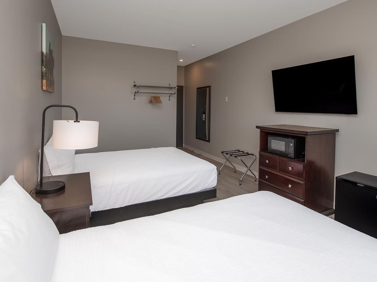 Two queen beds room with TV and mini-fridge at Coast Innisfail Hotel.