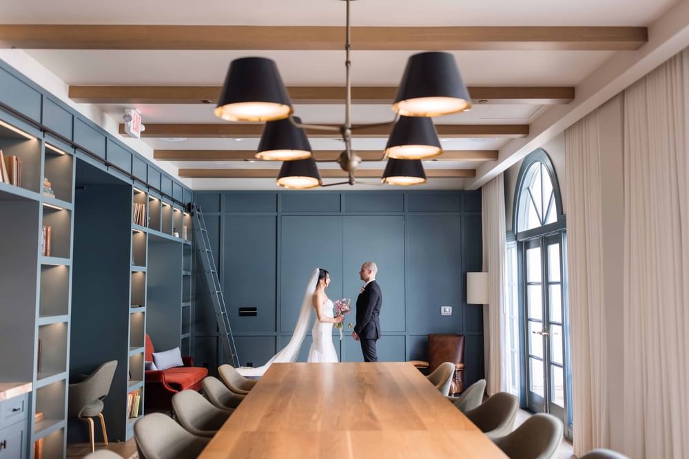 Beautiful bride and groom share a moment in a charming room at the El Prado Hotel