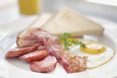 Close-up of Portuguese sausage with bacon & egg served in Ilima Cafe at Waikiki Resort Hotel by Sono