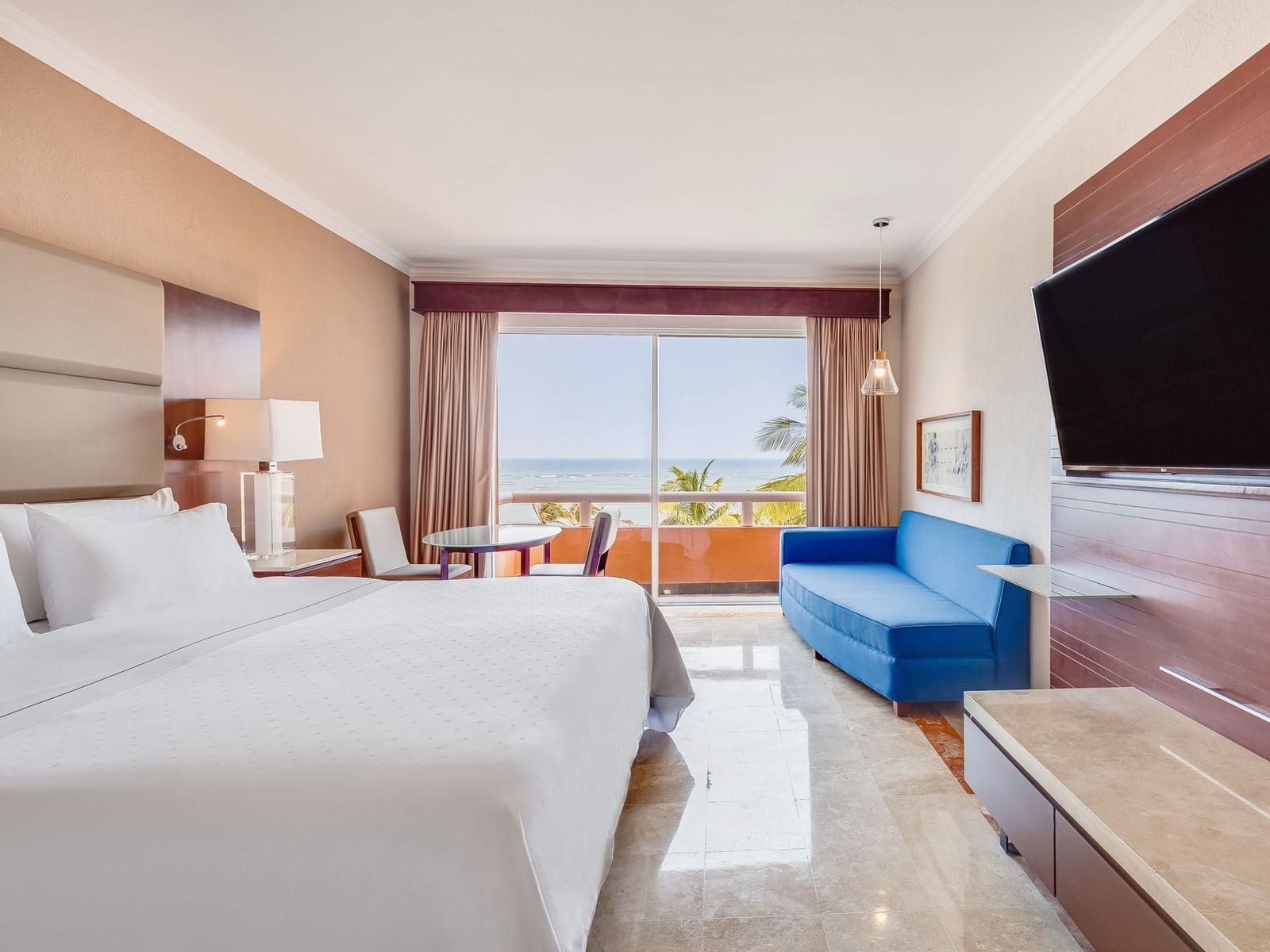 King bed, TV & Couch in Ocean view Deluxe Room at La Colección