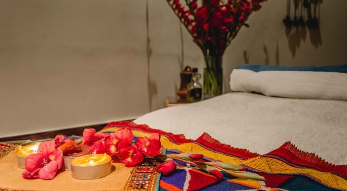 Candles & flower petals on a massage bed at Quetta Serena Hotel