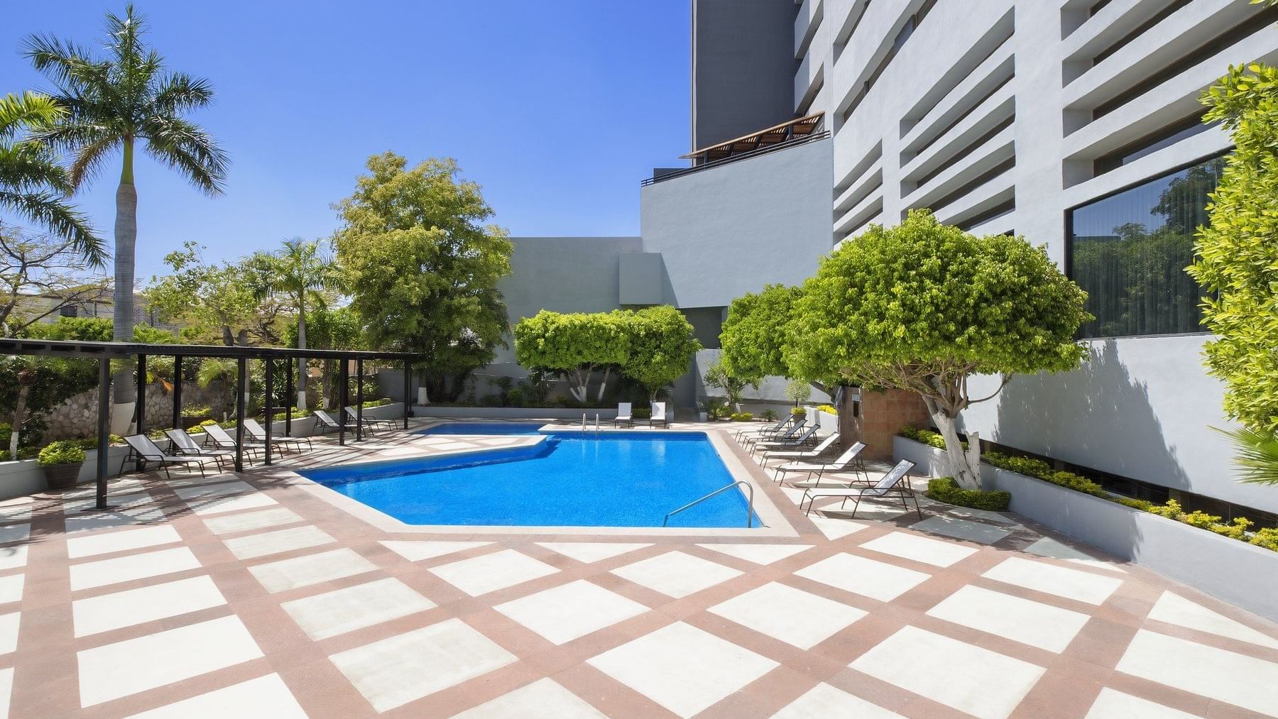 Pool area with sunbeds at Fiesta Americana Hermosillo