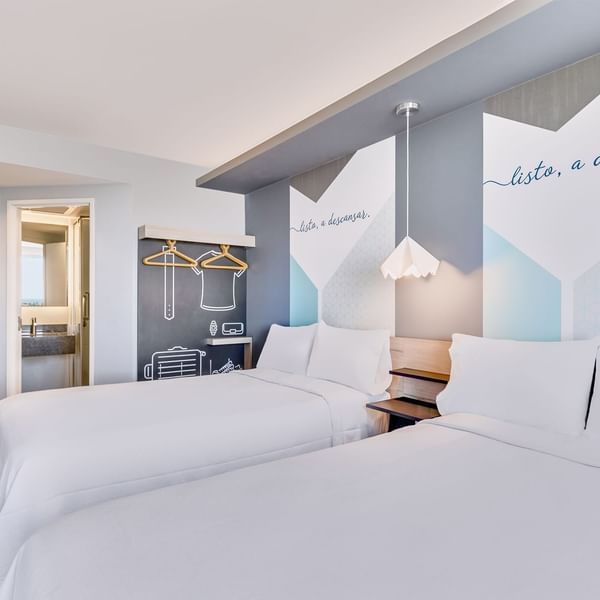 Comfy beds in Deluxe Two Queen at One Hotels
