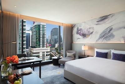 Furniture and a bed in Family room at Carlton Hotel Bangkok Sukhumvit