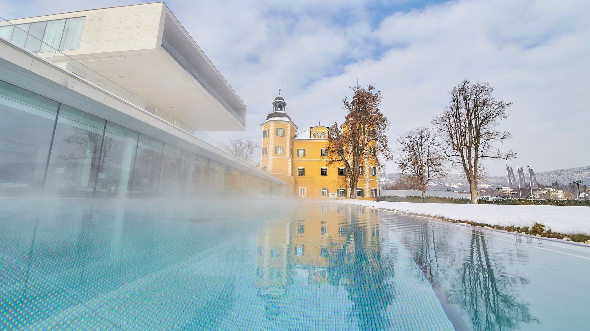 View of the outdoor pool area in Winter at Falkensteiner Schlosshotel Velden