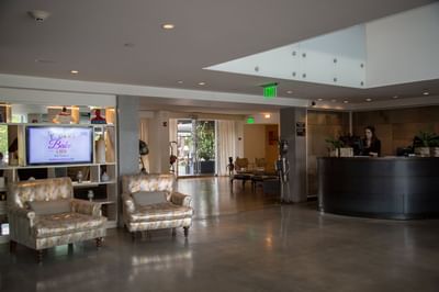 Reception desk by a curved wall at The J House Greenwich, a modern boutique hotel in Greenwich Connecticut