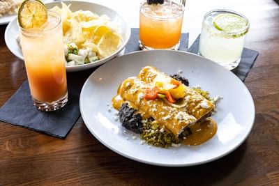 Plate of enchiladas with three drinks at Elevation Resort and Spa