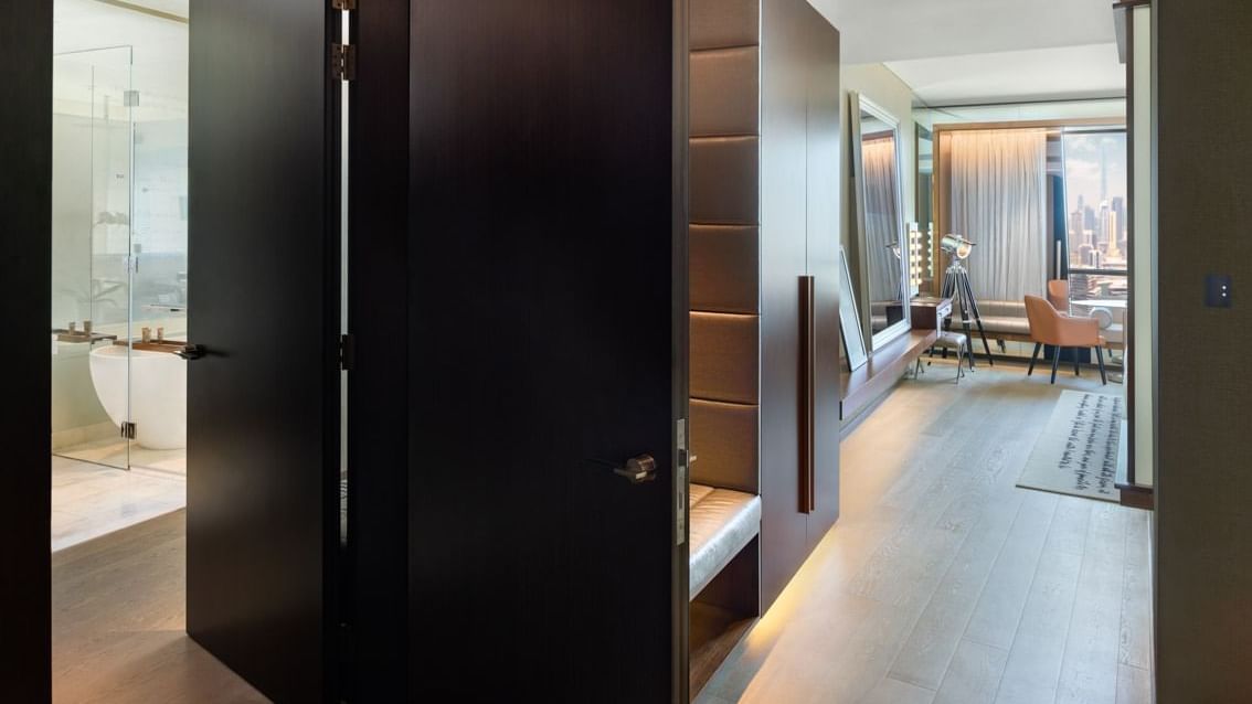 Scene Proscenium Room entrance with wooden doors and a glimpse of the sitting area and bathroom at Paramount Hotel Dubai