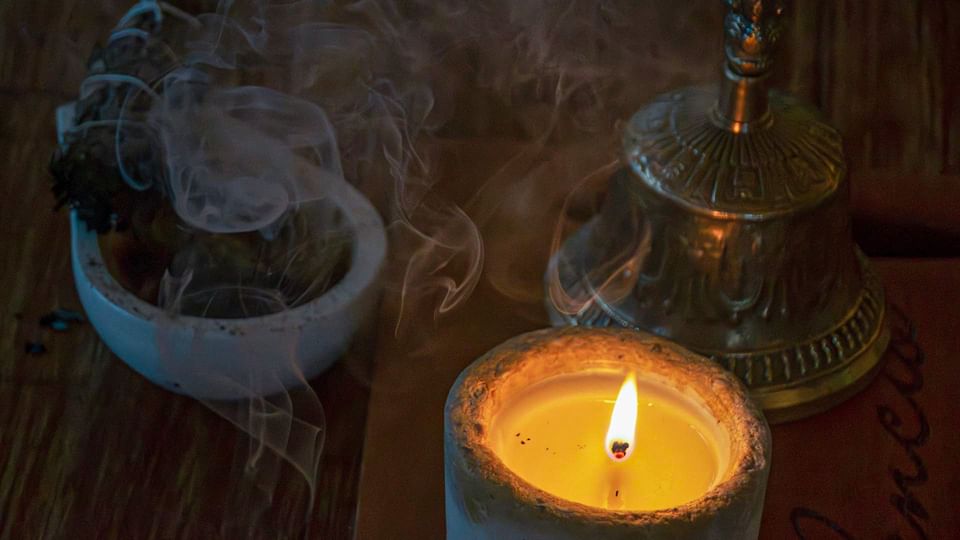 A lit candle with smoke from incense in Wellness Center at El Silencio Lodge & Spa