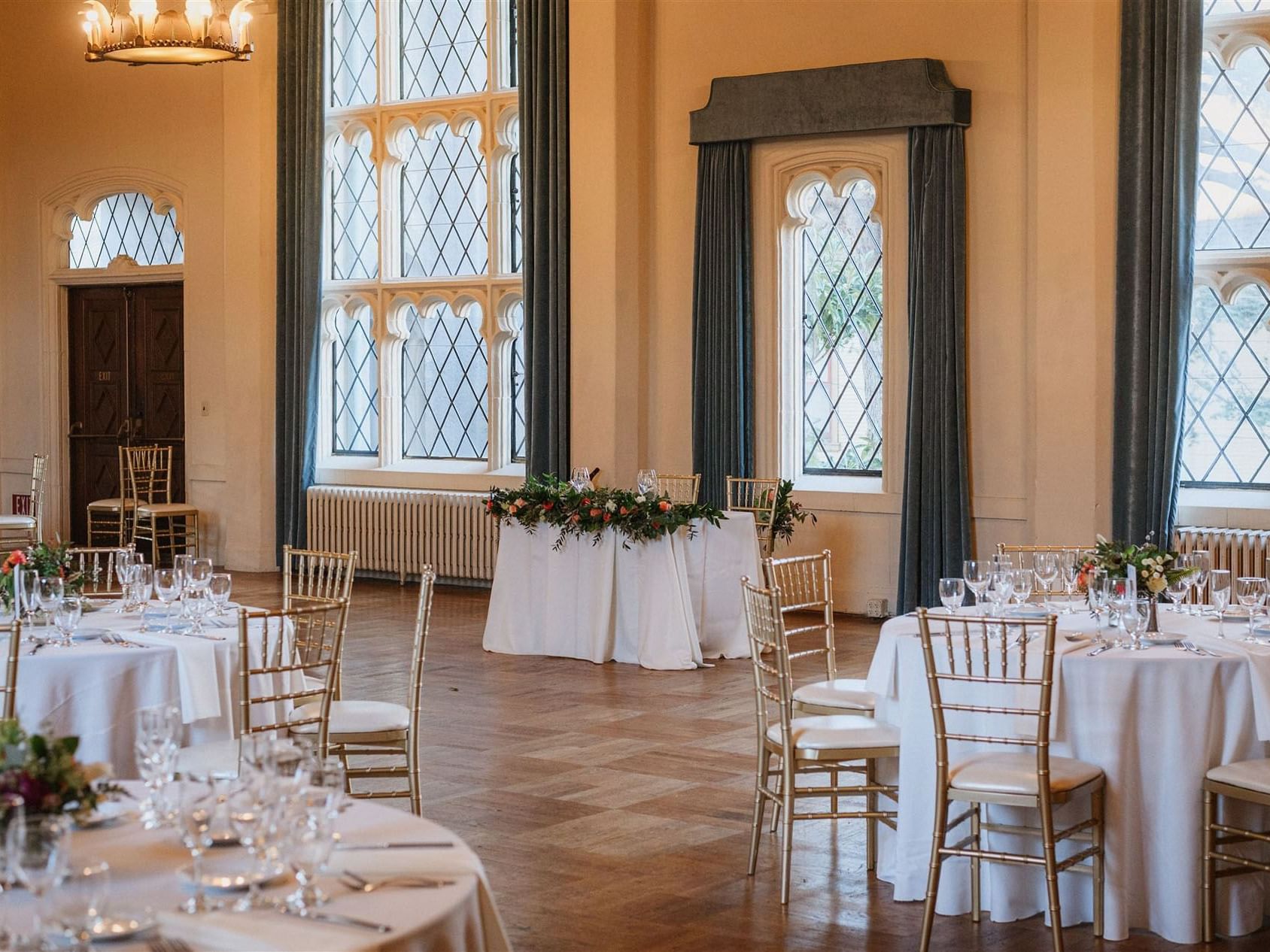 Banquet tables arranged in Venetian Ballroom with wooden floors at Berkeley City Club